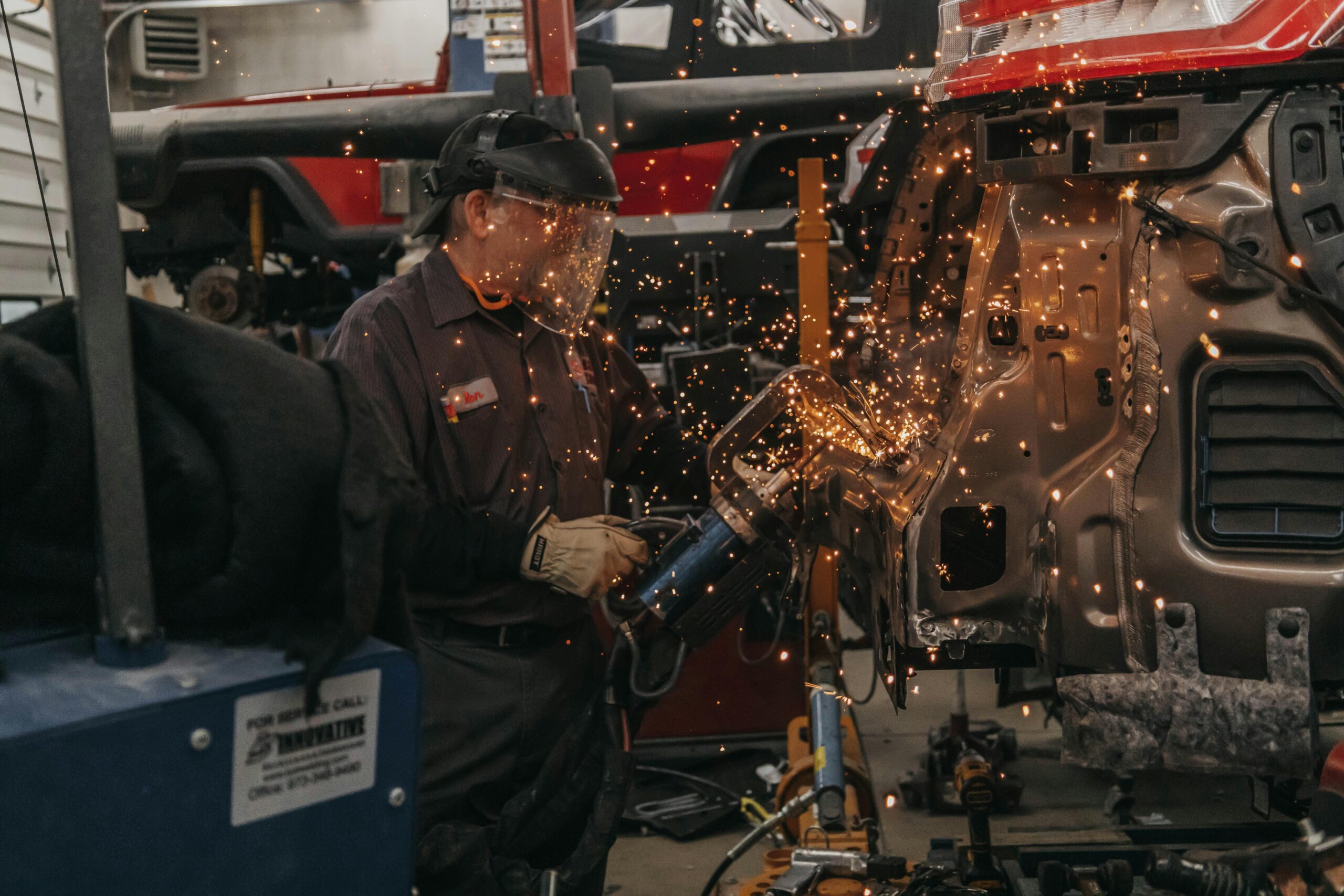 Bodywork in a workshop: metal being welded onto a vehicle