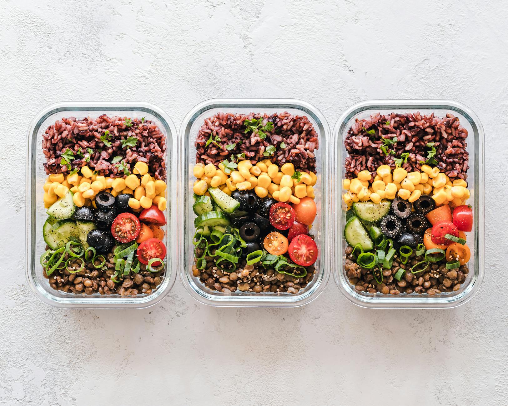 Pre-cooked meals in glass and bowl containers with vegetables, ready for the week