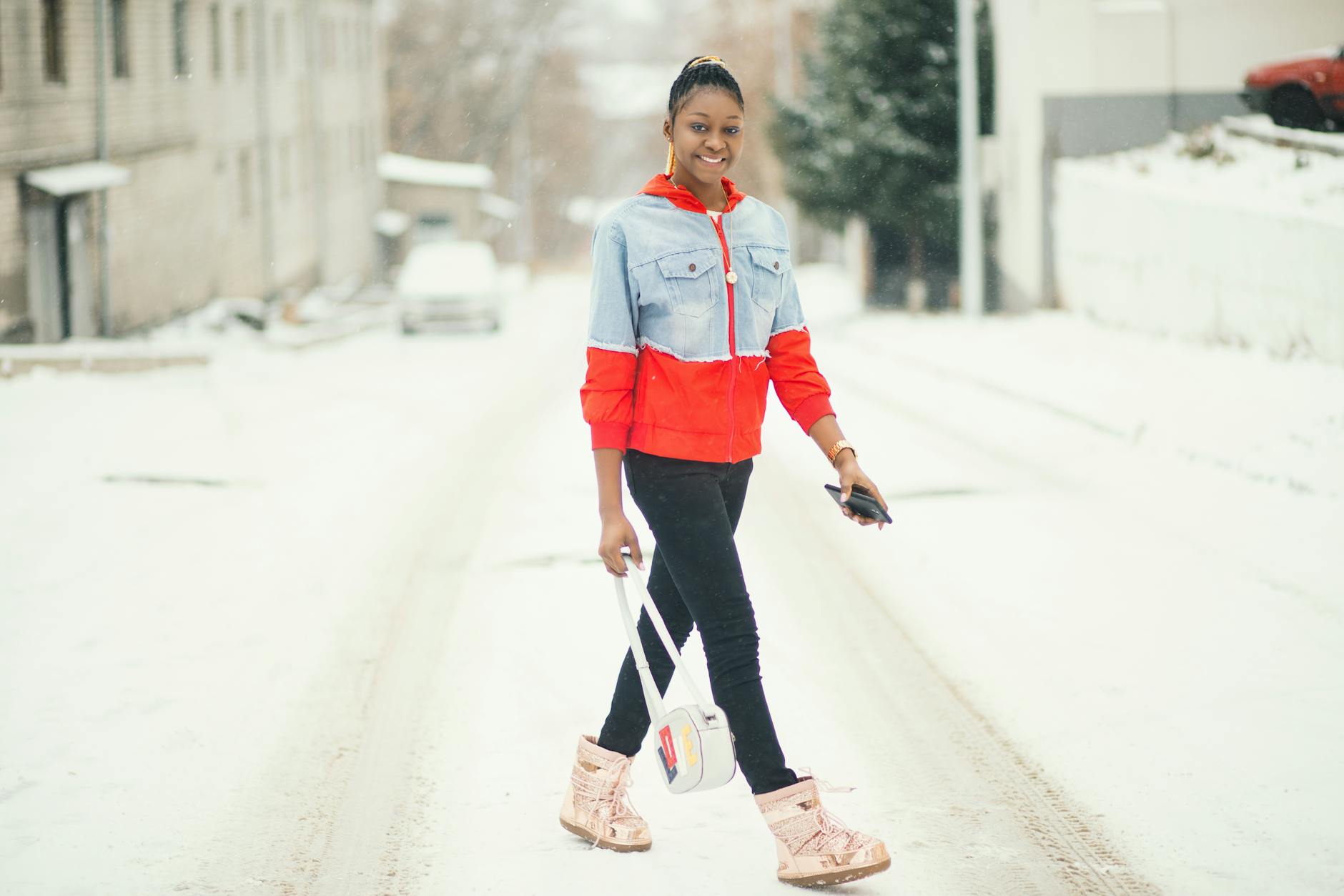Woman in winter coat and boots on a snowy street
