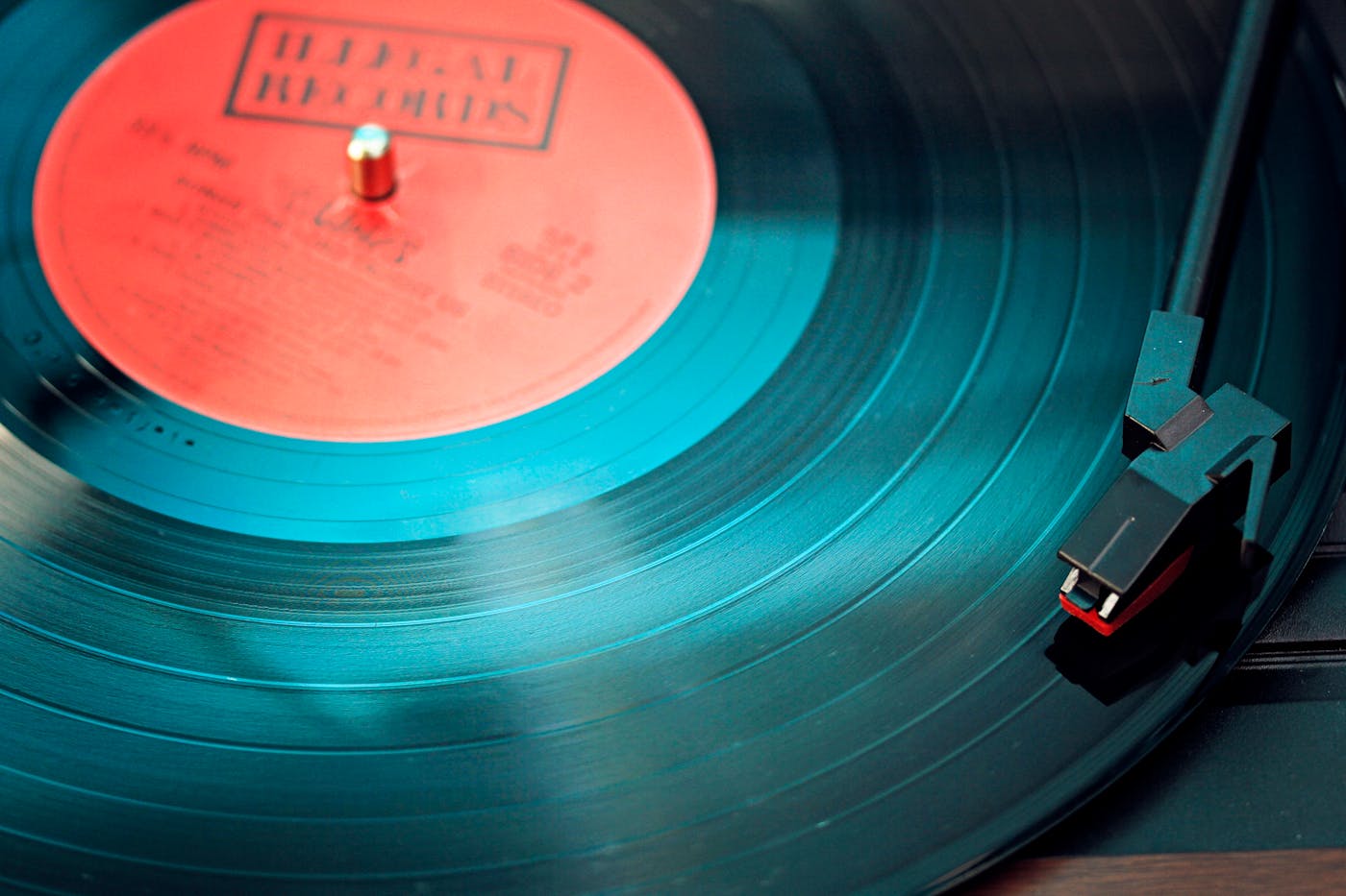 A vinyl record spins on a turntable, the needle in the groove