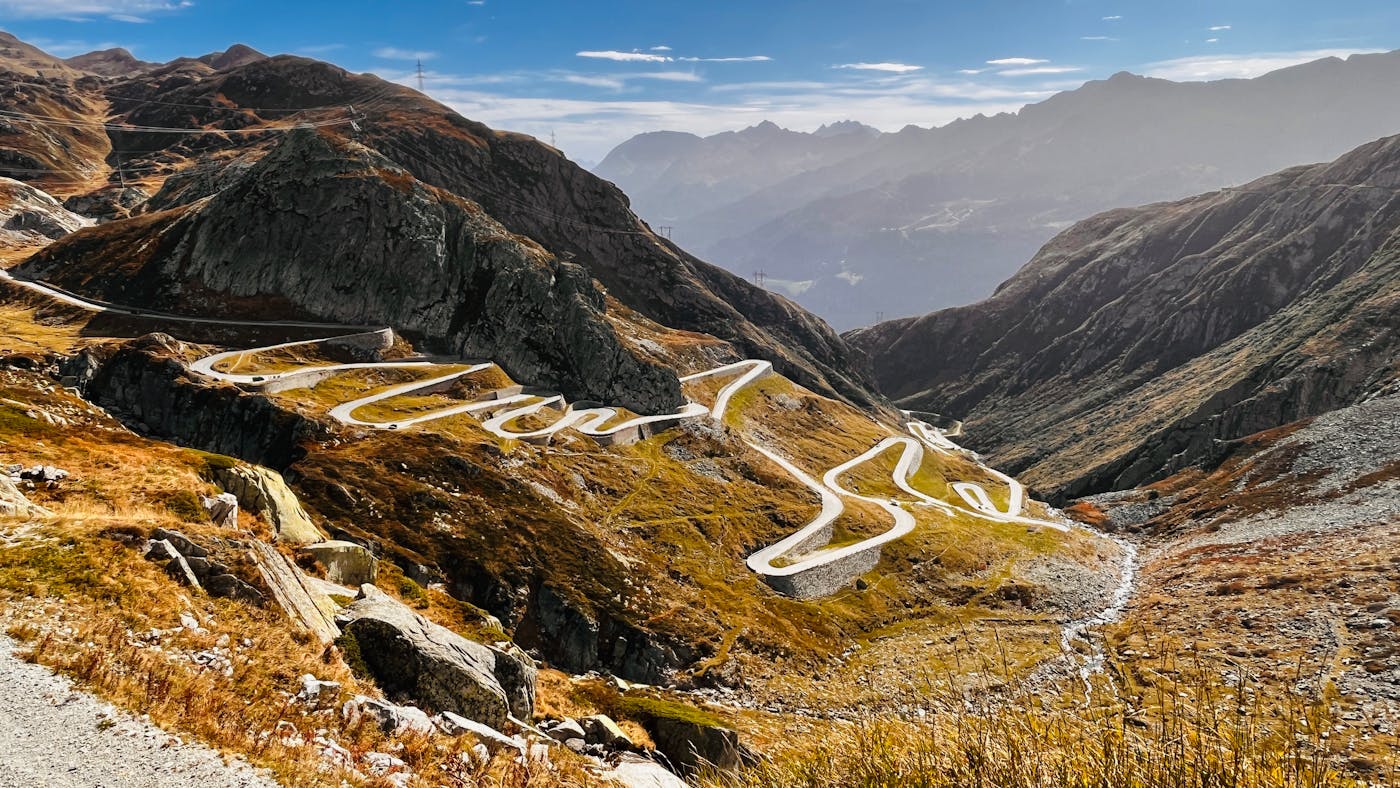 Winding track through forested slopes