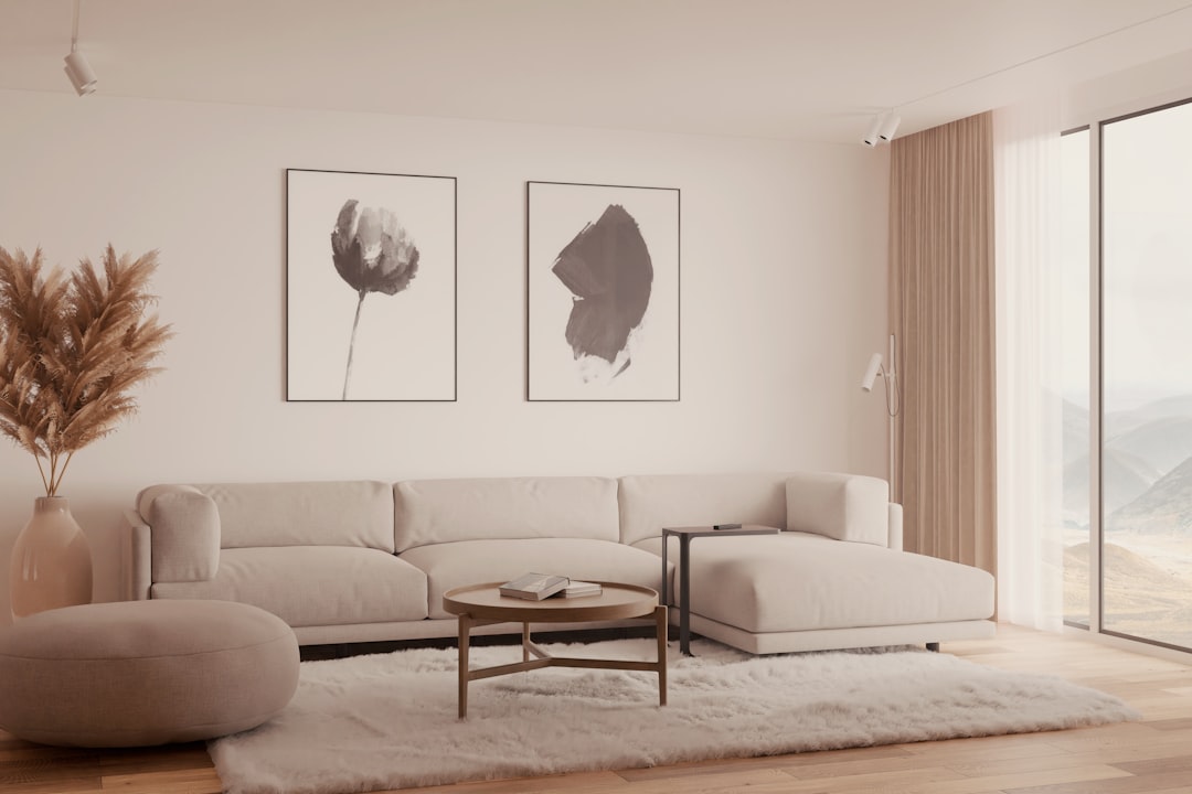 Quiet warm minimalism with beige sofa, oak floor and daylight