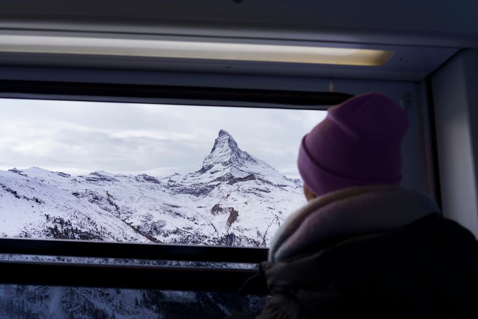 View through a train’s panoramic window of the snow-covered Matterhorn
