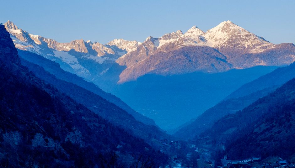 Snow-covered Alpine valley in the blue morning light
