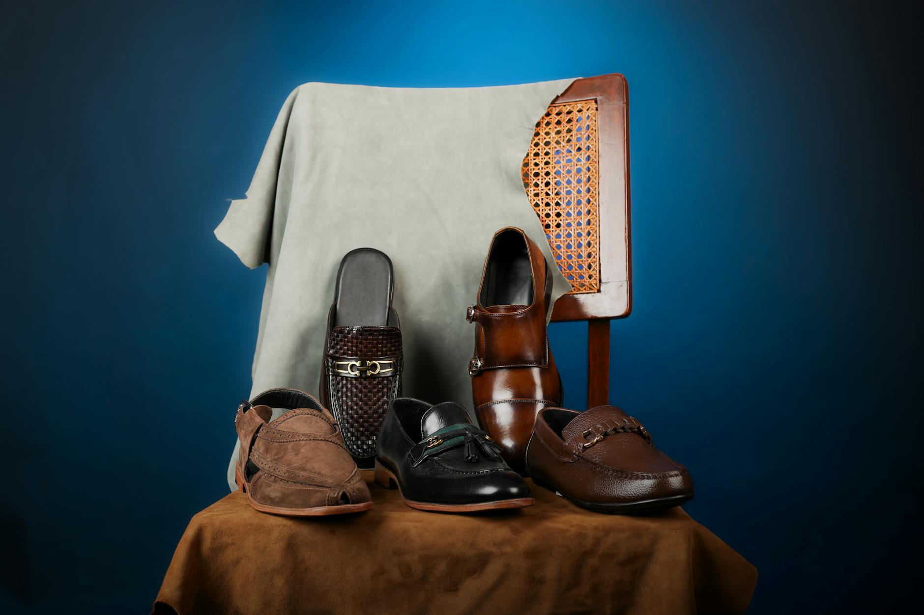 Handcrafted men's shoes arranged on suede