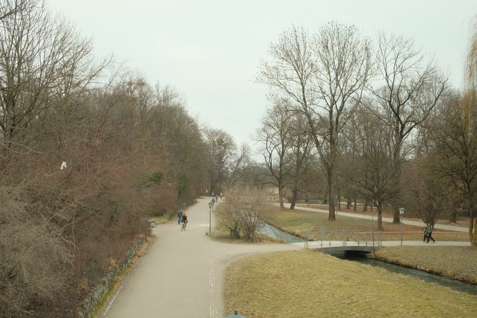 Weite Parkwege im Westpark Muenchen mit Bruecke und Baeumen im Winter