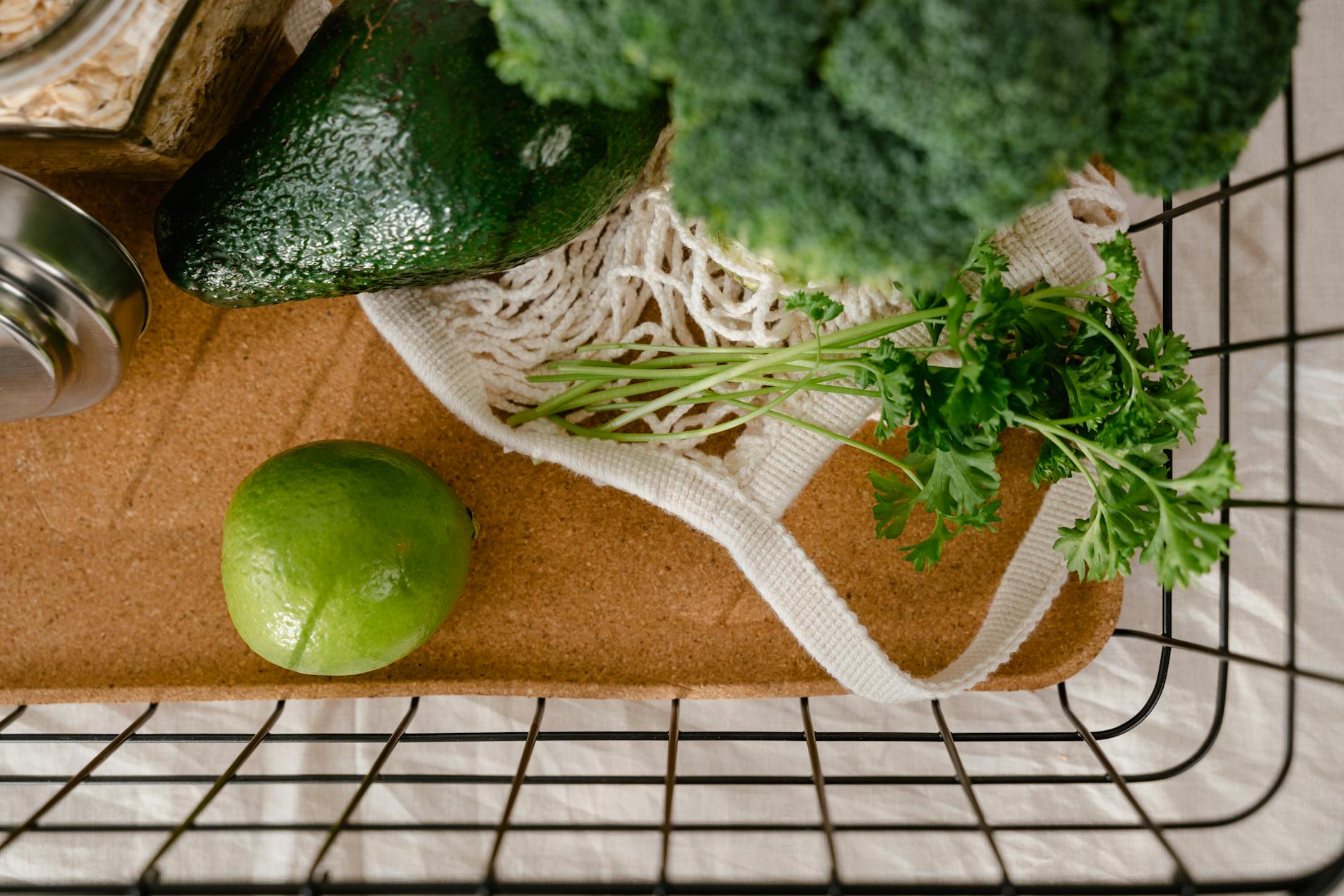 Top view of a grocery basket filled with fresh organic produce, promoting an eco-friendly lifestyle.