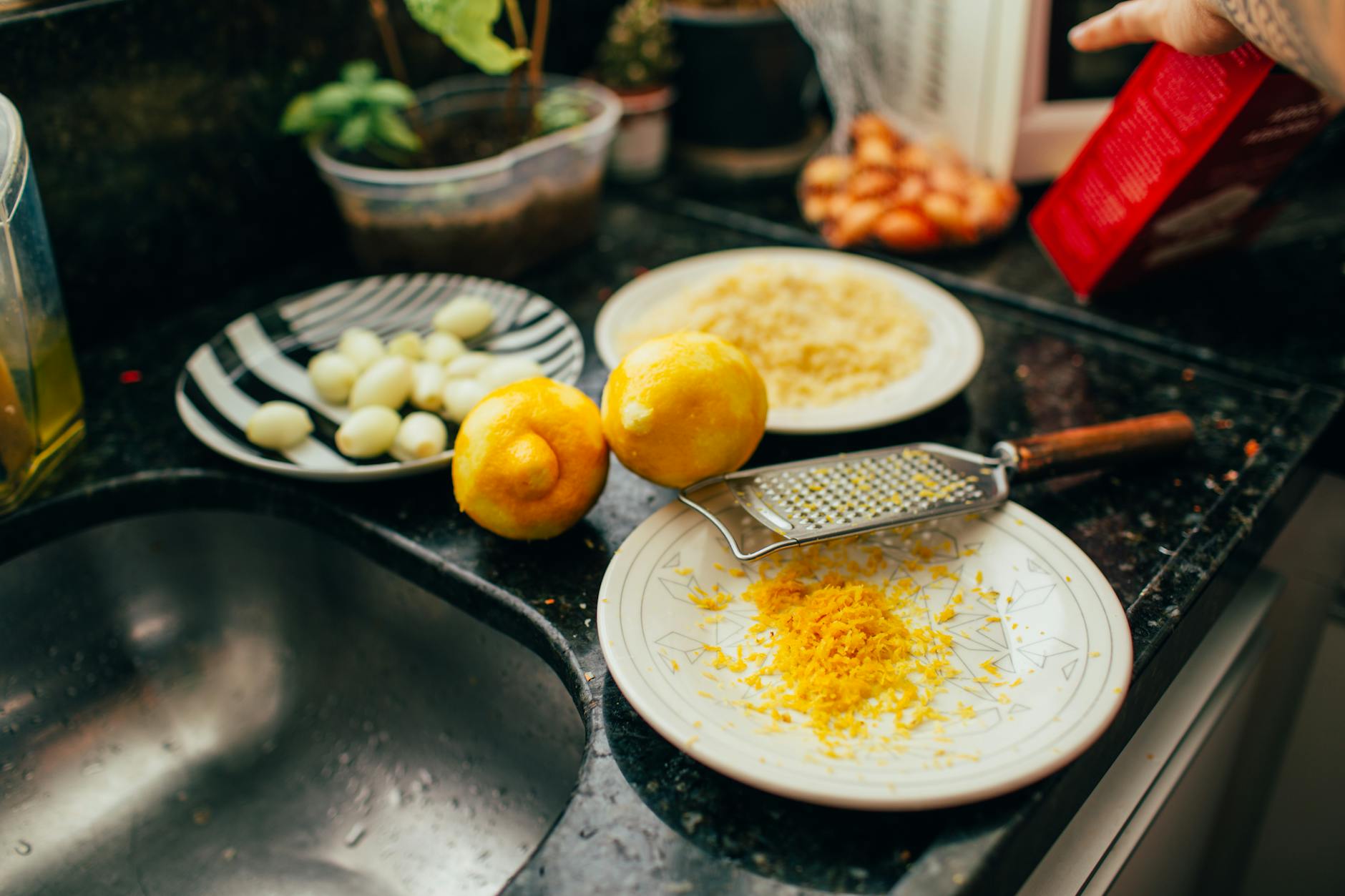 A kitchen scene with lemons and zest, showcasing a preparation process with fresh ingredients.