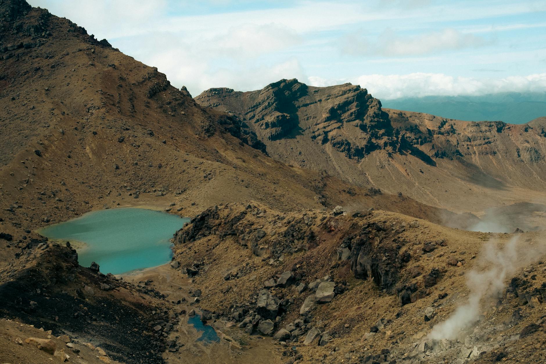Explore the stunning volcanic landscape of Tongariro Alpine Crossing in New Zealand.
