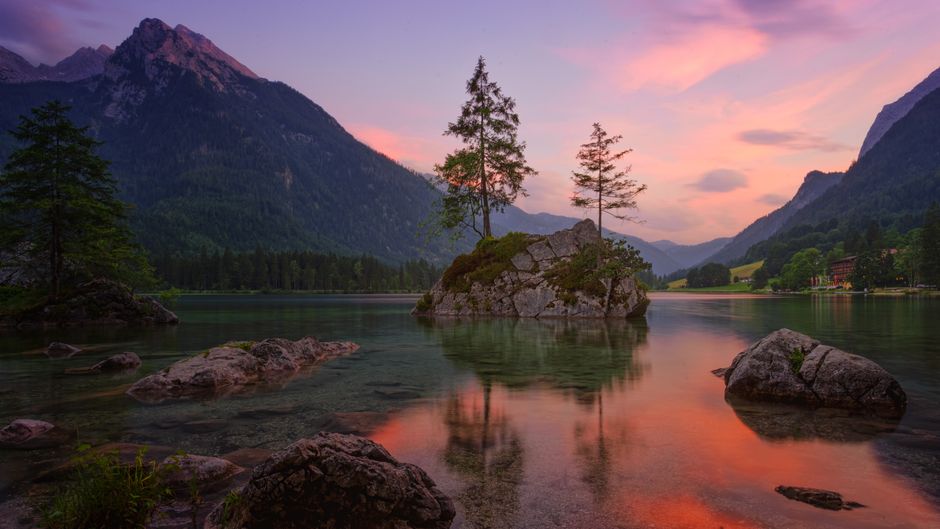 Alpine lake at sunset with a small rocky island