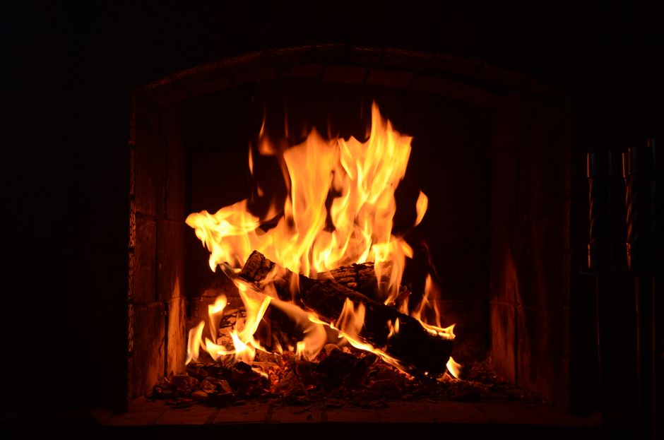 You watch the fire lick the solid stone hearth, its glow filling the space.